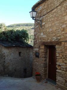 an old stone building with a door and a lamp at La Zambrana rural house in Erías