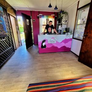 a man standing at a counter in a restaurant at Lago Argentino B&B in El Calafate