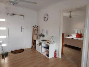 a room with a bedroom with a bed and a closet at Lavender Cottage - At home in Lightning Ridge in Lightning Ridge +23 photos