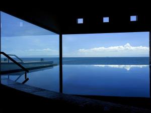 a view of the ocean from a house with a swimming pool at Awaji Yumesenkei in Sumoto