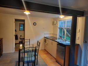 a kitchen with a table and a dining room at Spiral Gardens Country Park Retreat in Raurimu Spiral