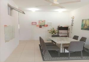 a dining room with a table and chairs at Samarahan Homestay 3-bedrooms house in Kuching