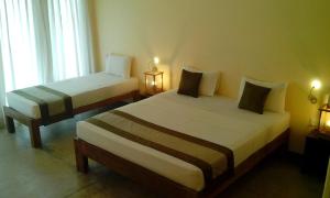 Voodi või voodid majutusasutuse Giman Free Beach Resort toas