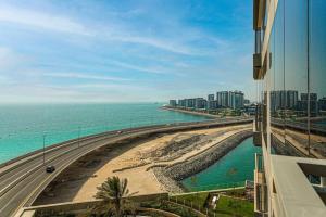 a view of a beach and the ocean from a building at Blu Water Luxury Tow Bedroom Apartment - Marina in Dubai