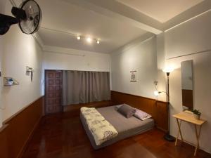 a bedroom with a bed and a ceiling fan at Freedom8 in Khlong San