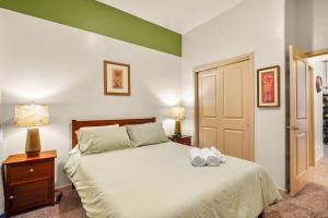 a bedroom with a bed with two towels on it at Casa Agave - Comfortable Eastlake Retreat in El Paso