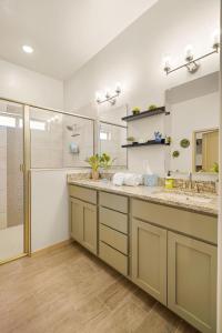 a bathroom with two sinks and a shower at Casa Agave - Comfortable Eastlake Retreat in El Paso