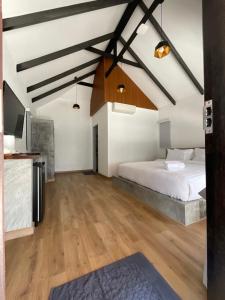 a bedroom with a large bed and a wooden floor at Island Spa Resort in Ko Tao