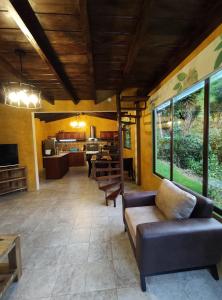 a living room with a couch and a table at "Casa Verde" en Baños de Agua Santa con vista al volcán Tungurahua in Baños