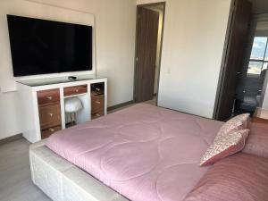 1 dormitorio con 1 cama grande y TV de pantalla plana en Sabaneta lujoso 3 habitaciones, en Medellín