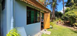a wine tasting room with a blue and green building at Pointe Venus Lodge in Mahina