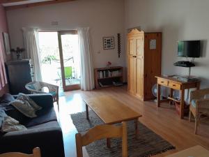 a living room with a couch and a table at Dorset Cottage in Cape Town