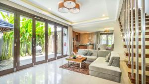 a living room with a couch and a table at Sotis Villas Canggu in Canggu