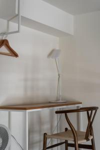 a desk with a chair and a lamp on it at Anping Kensington Hotel in Anping