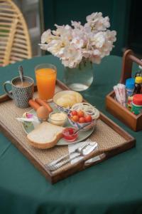 a tray with breakfast food on a table with juice at โรงแรมมีวาสนา - Me Vadsana Hotel 