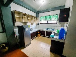a kitchen with a refrigerator and a sink at Convenient 3-Bedroom Apartment in Baguio