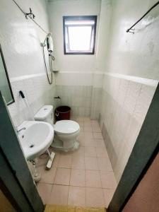 a bathroom with a toilet and a sink at Convenient 3-Bedroom Apartment in Baguio