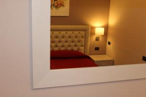 a bedroom with a bed with a red bedspread at Hotel Adler in Menaggio