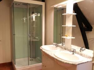 a bathroom with two sinks and a glass shower at Gîte Saint-Sauvier, 3 pièces, 6 personnes - FR-1-489-404 