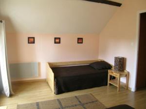 a bedroom with a large bed and a table at Gîte Saint-Sauvier, 3 pièces, 6 personnes - FR-1-489-404 