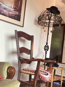 a chair and a lamp in a room at La casa di carlo in Lavarone
