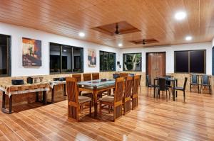 a dining room with a table and chairs at Pawna Mountain View 4BHK in Āmbavna