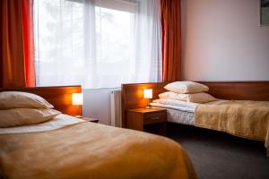 Łóżko lub łóżka w pokoju w obiekcie Wołosań B&B