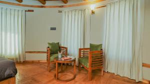 a bedroom with a table and chairs and a bed at Dakpa House Ladakh in Ranbirpura