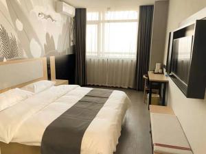 a bedroom with a large bed and a television at Thank Inn Chain Hotel hebei langfang gymnasium in Langfang