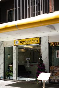 a store front with a christmas tree in front of it at Amber Inn in Bangkok