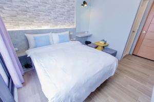 Cama ou camas em um quarto em Huayu Homestay