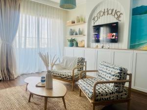 a living room with two chairs and a table at FLC Sea Tower Quy Nhơn - Homostay in Quy Nhon