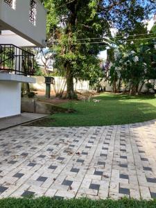 a brick walkway in a yard next to a house at GREEN Palace in Maharagama