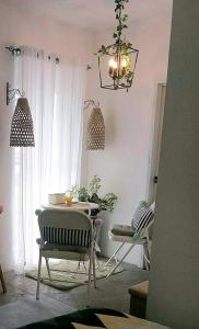 sala de estar con mesa, sillas y lámpara de araña en Dolores Residences Rm Bianca, en General Santos