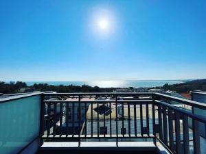 a balcony with a view of the ocean at 浯島文旅WD Hotel in Jinhu
