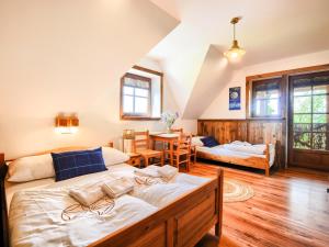 a bedroom with two beds and a dining room at Gościniec Rabe - Agro&SPA in Ustrzyki Dolne