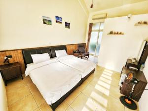 Katil atau katil-katil dalam bilik di Yuzhou Garden B&B