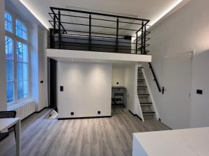 Habitación vacía con altillo y escalera en Pere Lachaise Apartment en París
