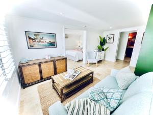 a living room with a couch and a table at The Boathouse at Whitesands Cronulla in Cronulla