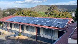 a house with solar panels on top of it at Lithgow Motor Inn in Lithgow