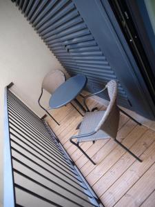 two chairs and a table on a wooden deck at New Style Lisbon Hotel in Lisbon