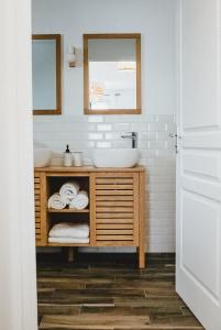 a bathroom with a sink and a mirror at Villa Couleur Nature in Salazie +25 photos