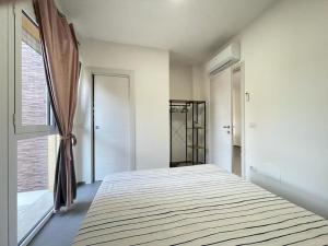 a large bed in a room with a window at Nuovo a 40 passi dal mare. A casa di “Bicca” in Tortoreto Lido