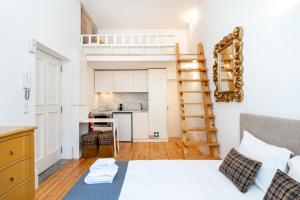 a small bedroom with a bed and a kitchen at VIVA Library Studio in Porto