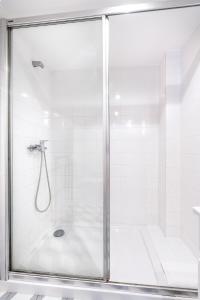 a shower with a glass door in a bathroom at VIVA Library Studio in Porto