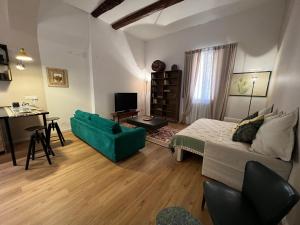 a bedroom with a bed and a desk and a couch at HouSmart Senzanome 9/3 in Bologna