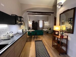 a living room with a kitchen and a living room with a couch at HouSmart Senzanome 9/3 in Bologna