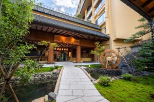 a building with a pond in front of it at Sansuiso Tsuchiyu Spa in Fukushima