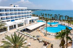 an aerial view of a hotel with a pool and the ocean at Ascos Coral Beach Hotel in Coral Bay +71 photos