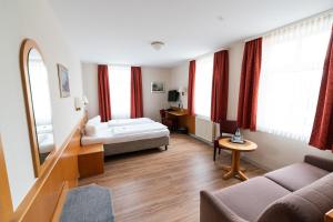 Postel nebo postele na pokoji v ubytování Hotel am Stadthaus